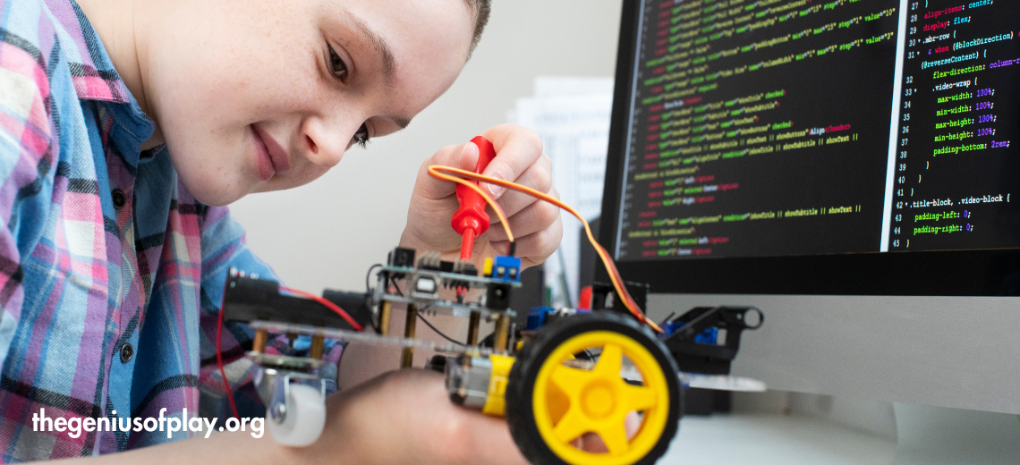 school-aged girl building robotic car in a science class