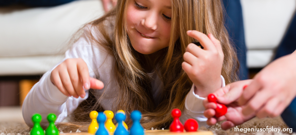 young girl concentrating while playing a board game