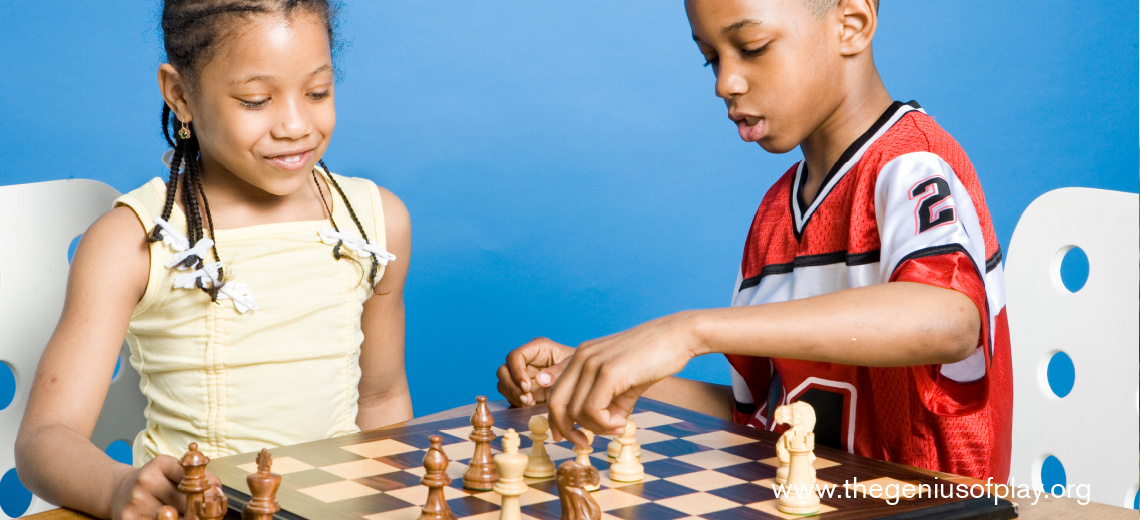 African American boy and girl playing chess