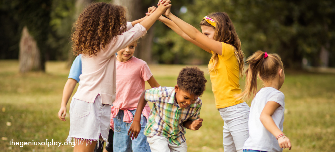 culturally diverse group of elementary school age children playing outdoors