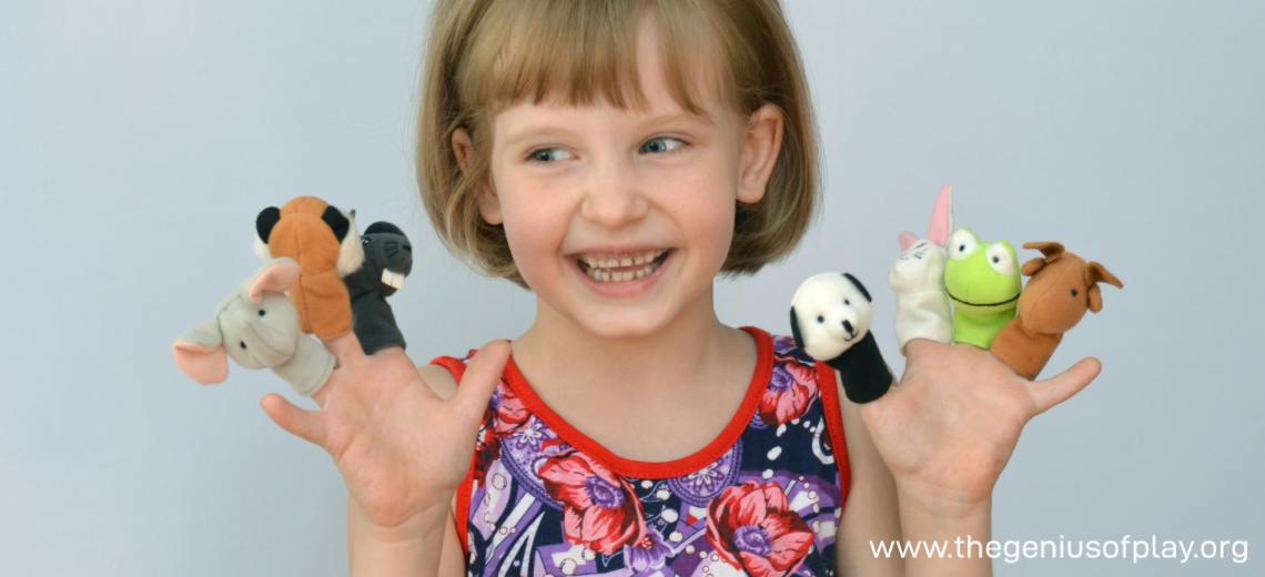 young child playing with finger puppets