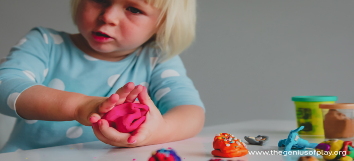 Upset young child playing with molding clay