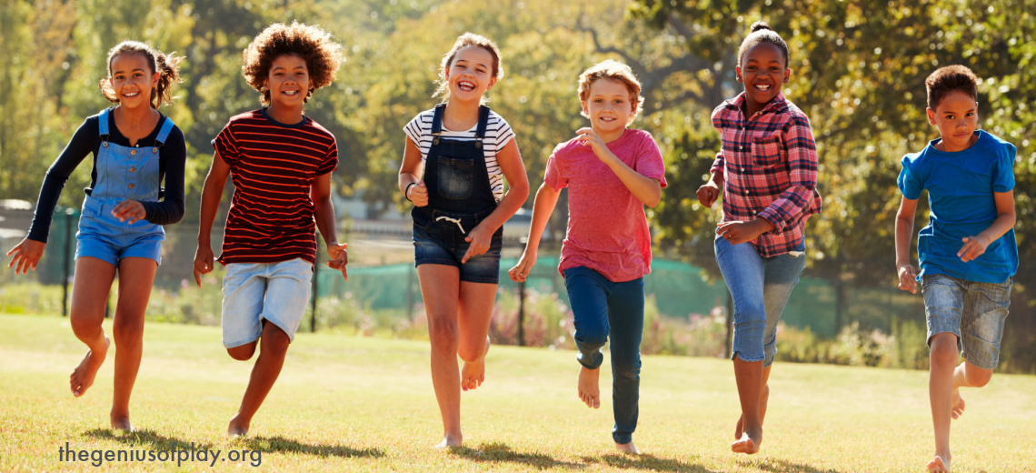 multi-cultural pre-teen kids running outdoors in an open field