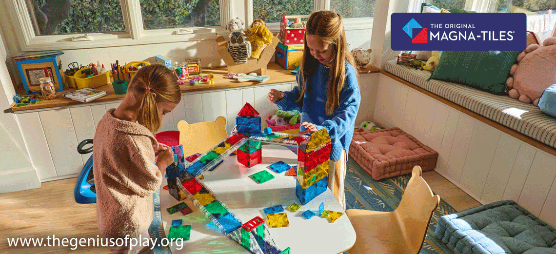 two young girls building and playing with colorful MAGNA-TILES