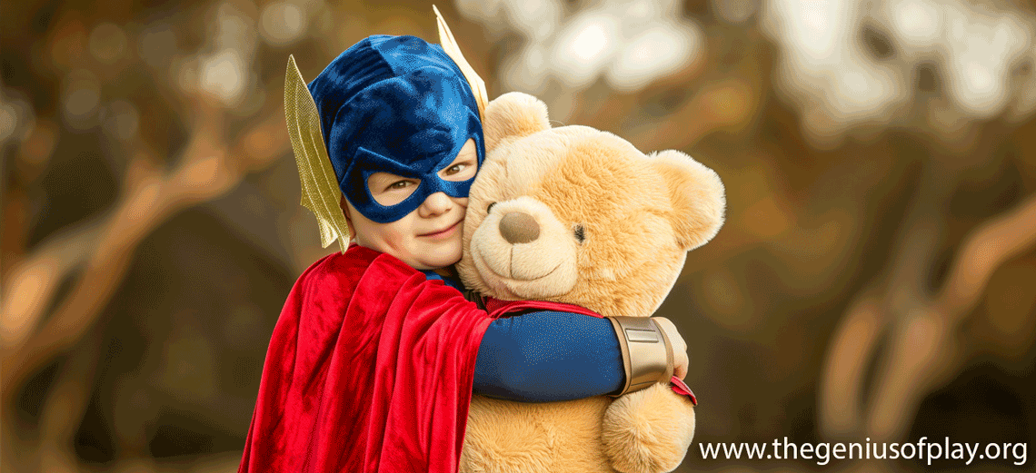 kid in superhero outfit hugging a teddy bear