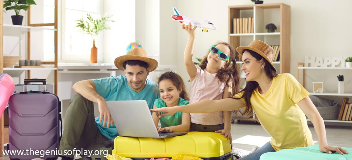  Mom, dad, young daughters sitting on suitcases planning to go on vacation